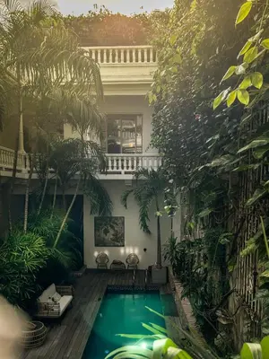 a swimming pool in the middle of a building with trees at Casa Belle Cartagena Hotel Boutique in Cartagena de Indias