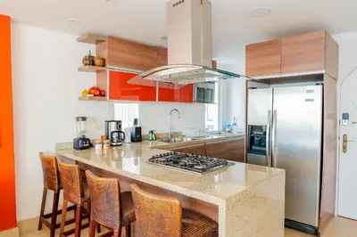 a kitchen with a counter top and a refrigerator at U-GO Playa Mar en El Laguito con Vista al Mar in Cartagena de Indias
