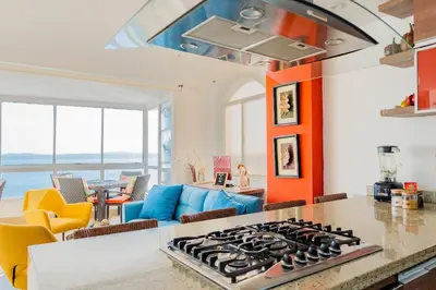 a kitchen and living room with a stove top at U-GO Playa Mar en El Laguito con Vista al Mar in Cartagena de Indias