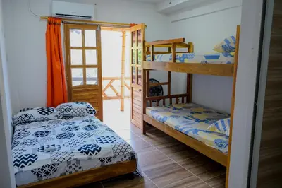 a bedroom with two bunk beds and a balcony at Cabañas en San Antero Bambumar3 in San Antero