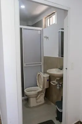 a bathroom with a toilet and a sink at Cabañas en San Antero Bambumar3 in San Antero