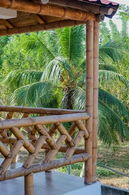 a wooden deck with a palm tree in the background at Cabañas en San Antero Bambumar3 in San Antero