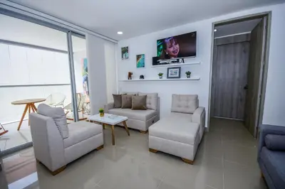 a living room with a couch and chairs and a tv at APARTAMENTO OCEAN DRIVE 410 CARTAGENA in Cartagena de Indias