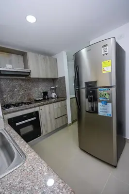a kitchen with a stainless steel refrigerator and a sink at APARTAMENTO OCEAN DRIVE 410 CARTAGENA in Cartagena de Indias