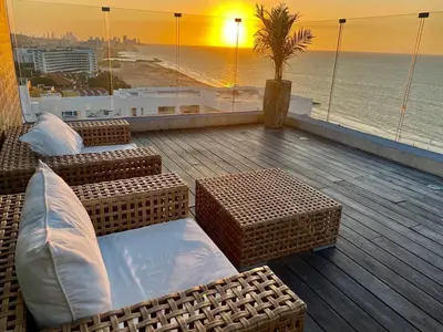 a balcony with chairs and a view of the ocean at Morros Cartagena frente a playa Hotel las Américas Edificio Spiaggia Apto Duplex in Cartagena de Indias