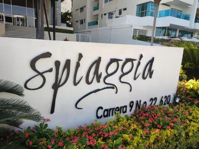 a sign for a hotel in front of some flowers at Morros Cartagena frente a playa Hotel las Américas Edificio Spiaggia Apto Duplex in Cartagena de Indias