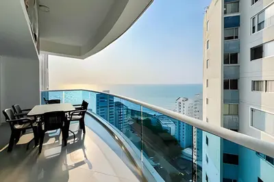 a balcony with a table and chairs and the ocean at Apartamento 2 Dormitorios Laguito. Vista Mar in Cartagena de Indias