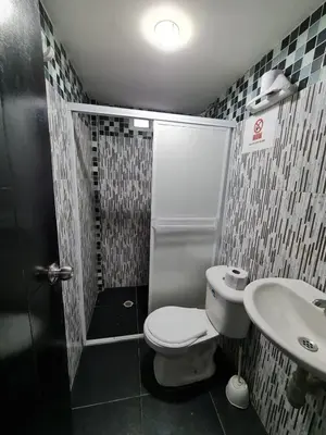 a small bathroom with a toilet and a sink at Apartamentos La Marina in Cartagena de Indias