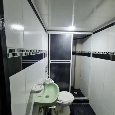 a bathroom with a green sink and a toilet at Apartamentos La Marina in Cartagena de Indias