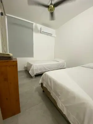 a bedroom with two beds and a ceiling fan at Apto Boho in Cartagena de Indias