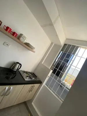 a small kitchen with a stove and a window at Apto Boho in Cartagena de Indias