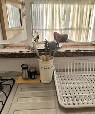 a dish rack with utensils on a kitchen counter at Apartamento vacacional cerca del mar in Cartagena de Indias
