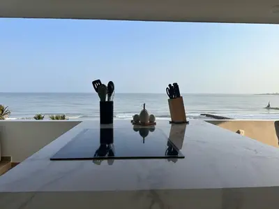 a dining table with a view of the ocean at U-GO Edificio Faro en El Laguito, Cartagena in Cartagena de Indias