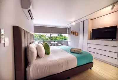 a bedroom with a bed with a flat screen tv at U-GO Edificio Faro en El Laguito, Cartagena in Cartagena de Indias