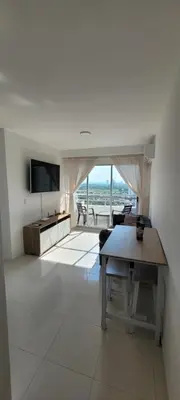 a living room with a table and a television at Hermoso apartamento cerca a las playas de Marbella en Cartagena in Cartagena de Indias