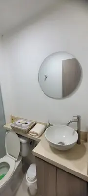 a bathroom with a sink and a toilet and a mirror at Hermoso apartamento cerca a las playas de Marbella en Cartagena in Cartagena de Indias