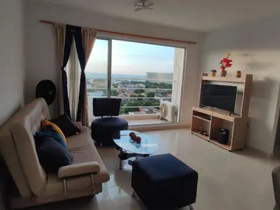 a living room with a couch and a large window at apartamento1108 in Cartagena de Indias