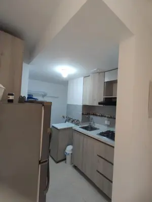a kitchen with wooden cabinets and a sink and a refrigerator at apartamento1108 in Cartagena de Indias
