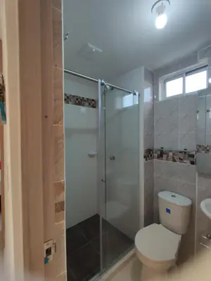 a bathroom with a toilet and a glass shower at apartamento1108 in Cartagena de Indias
