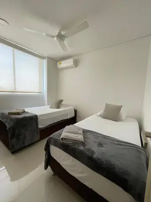 a bedroom with two beds and a window at Cartagena Seaview Elegance in Cartagena de Indias