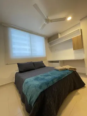a bedroom with a large bed in front of a large window at Cartagena Seaview Elegance in Cartagena de Indias