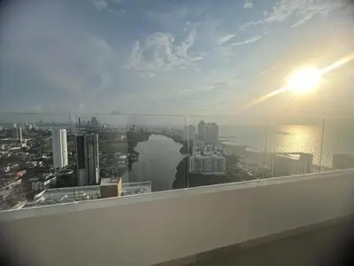 a view of a city from a building with the sun at Cartagena Seaview Elegance in Cartagena de Indias