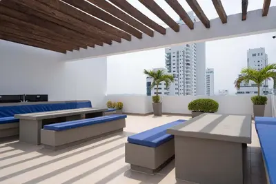 a room with blue tables and benches in a building at Tres habitaciones - Vista al Mar in Cartagena de Indias