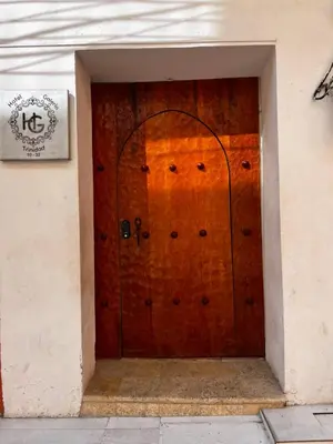 a wooden door of a building with a sign on it at Hotel Galeria la Trinidad in Cartagena de Indias