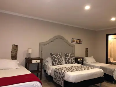 a hotel room with two beds and a window at Hotel Galeria la Trinidad in Cartagena de Indias