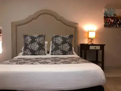 a bedroom with a large bed with two pillows at Hotel Galeria la Trinidad in Cartagena de Indias