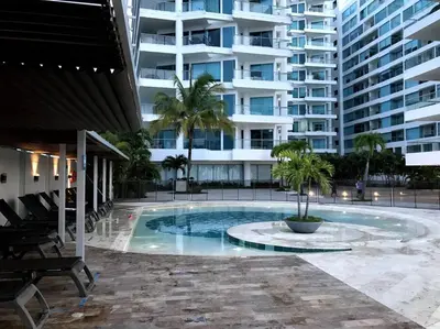 a swimming pool in front of a large building at Sensacional Apartamento nuevo frente al mar in Cartagena de Indias