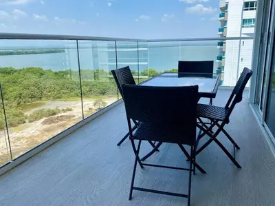 a table and chairs on a balcony with a view of the ocean at MQ 1006 Cartagena, Playa cercana in Cartagena de Indias