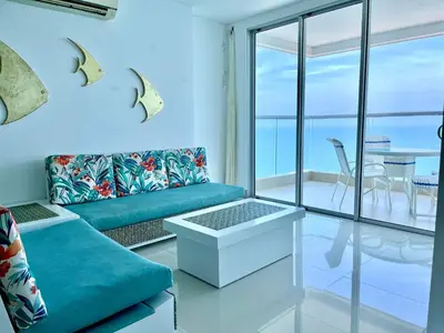 a living room with a couch and a view of the ocean at by Calamari Homes - Palmetto Beach 2504 Bocagrande in Cartagena de Indias