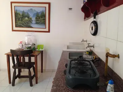 a kitchen with a stove and a sink at Cecil Aparta Estudios in Barranquilla