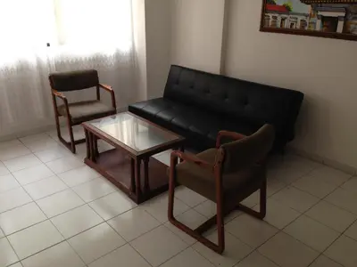 a living room with a couch and a table and chairs at Cecil Aparta Estudios in Barranquilla