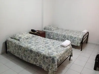 two beds in a small room with at Cecil Aparta Estudios in Barranquilla