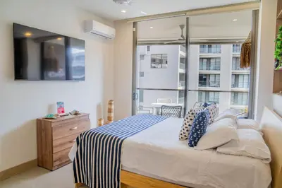 a bedroom with a large bed and a window at Fantastic Apartment/Beach Front Luxury in Cartagena de Indias