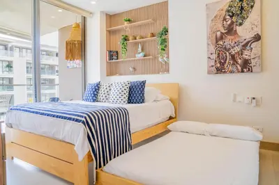 two beds in a small room with a window at Fantastic Apartment/Beach Front Luxury in Cartagena de Indias