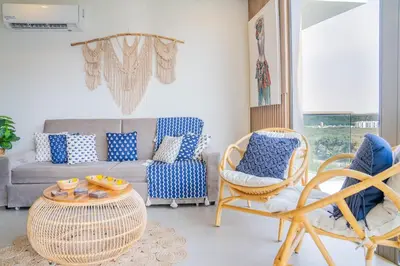 a living room with a couch and chairs and a table at Fantastic Apartment/Beach Front Luxury in Cartagena de Indias