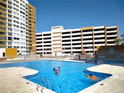 a group of people in a swimming pool with buildings at Apartamentos Condominio Oporto - Cerca a Todo in Barranquilla