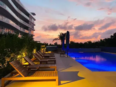 a pool with chaise lounge chairs and a hotel at ¡Wonderful Beach Loft! in Cartagena de Indias
