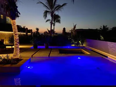 a swimming pool with blue lights next to a building at ¡Wonderful Beach Loft! in Cartagena de Indias