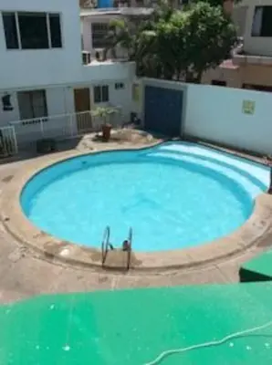 a large swimming pool in front of a building at Habitación privada en Bocagrande in Cartagena de Indias