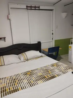 a large bed in a room with a large window at Habitación privada en Bocagrande in Cartagena de Indias