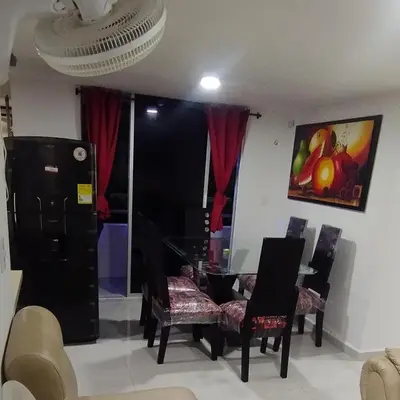 a living room with a dining room table and chairs at Hospedaje y Alojamiento Familiar in Coveñas