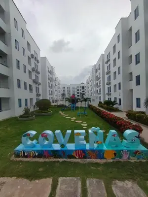 a playground in a park in front of apartment buildings at Hospedaje y Alojamiento Familiar in Coveñas