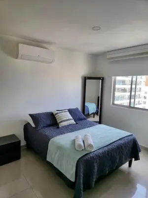 a bedroom with a bed with two towels on it at Apartamento con vista al mar y al centro de Cartagena in Cartagena de Indias
