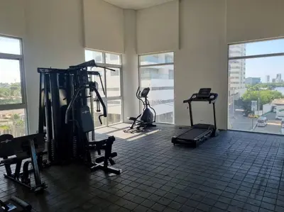 a gym with several exercise bikes in a room with windows at Apartamento con vista al mar y al centro de Cartagena in Cartagena de Indias
