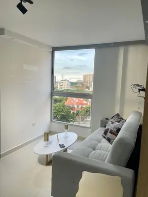a living room with a couch and a large window at Moderno apartamento al norte de Barranquilla in Barranquilla