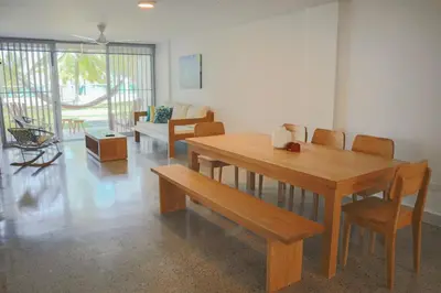 a dining room with a wooden table and chairs at Magico Apartamento Frente al Mar 3 Habitaciones C11A in Coveñas